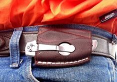 a man wearing a leather belt with a knife in his pocket