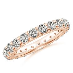 a rose gold ring with five diamonds on the side and two rows of round stones