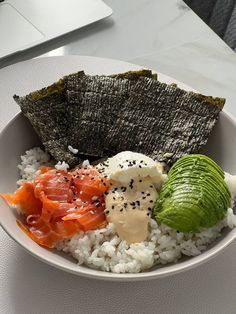 a white bowl filled with rice and vegetables