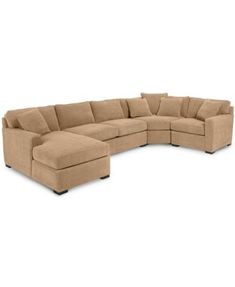 a large sectional couch with pillows on it