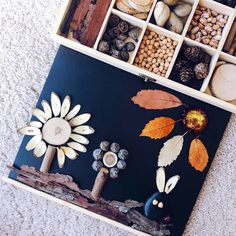 a box filled with lots of different types of decorations on top of a white carpet