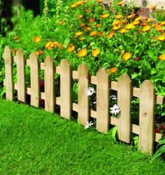 a wooden fence with flowers growing behind it