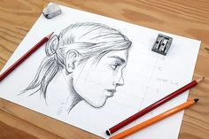 a pencil drawing of a woman's face on top of a piece of paper