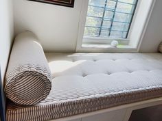 a mattress is laying on the floor in front of a window