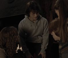 the harry potters are talking to each other in front of some girls and one man