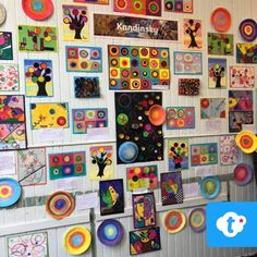 a wall covered in lots of colorful art pieces