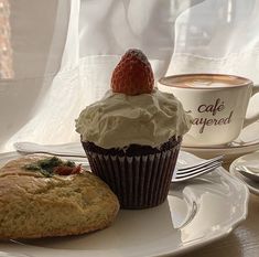 a cupcake and muffin on a white plate