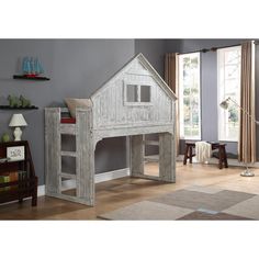 a child's bedroom with a loft bed, desk and bookshelf in it