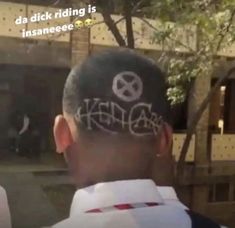 the back of a man's head with graffiti written on it and an image of a peace sign behind him