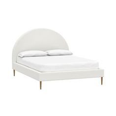 a bed with white linens and wooden legs on the headboard, against a white background