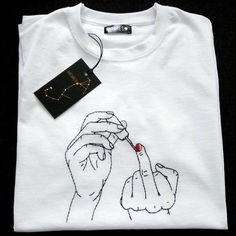 a white t - shirt with a drawing of a woman's hand holding a string