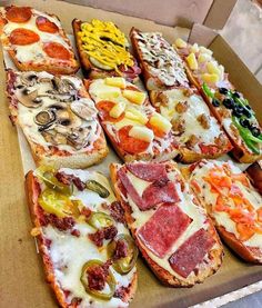 a box filled with different types of pizzas on top of each other and toppings