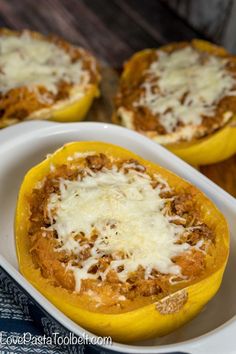 stuffed bell peppers with cheese on top in a white casserole dish, ready to be eaten