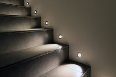 some lights that are on the side of some stairs