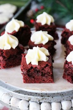 several pieces of red velvet cake with white frosting