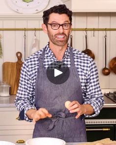 a man standing in front of a kitchen counter with an egg on top of it