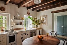 a kitchen with a table, stove and sink in it's center island next to a window