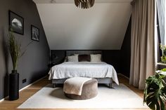 a bedroom with a large bed and white carpeted flooring next to a window