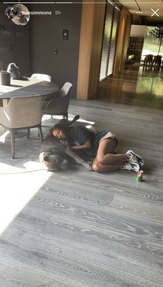 a woman laying on the floor with her dog