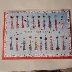 a card with christmas trees and stars on it