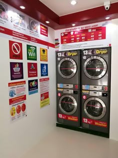 two washers are on display in front of the dryer's sign and posters