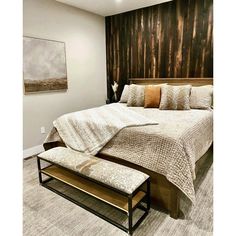 a large bed sitting next to a wall with wood panels on it's headboard