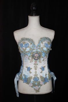 Satin cupped corset with various ornamental embroidery. It has plastic boning with steel bone reinforcements and lace-up sides. The corset is airbrushed with an ombre color. Made to order to buyer's measurements. Custom Color requests are welcome. Lace Festival Corset, Festival Lace Fitted Corset, Cupped Corset, Faerie Costume, Wicked Costumes, Elizabethan Collar, Floral Teacup, Cute Birthday Outfits, Corset Fashion