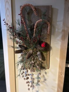 pine cones and berries are hanging on the front door