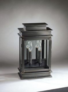 an old fashioned lantern with two candles inside