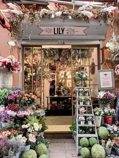 a flower shop with lots of flowers on display