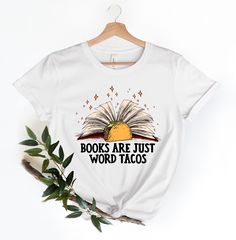 Books Are Just Word Tacos Shirt, Reading Shirt, Teacher Shirt, Teacher Gifts, Book Lover Shirt, Librarian Tee, Taco Lover Shirt ♥ HOW TO ORDER T-SHIRT ♥ 1- Please, Check and Review all Photos.,  2- Choose your size from the drop-down menu and add each shirt to your cart one at a time. 3- Select Your Shirt Color from Drop-down 2 which is Shirt Color. 4- Choose Your TEXT Color. Please add your text color on to the personalization box. 5- Your shipping will automatically combine when ordering multiples. 6- Checkout out all at once when the correct color and qty has been added. 7- Finally, Your Custom Shirt will be ready to ship 1-3 Business Day. Holiday times may affect the handling times. -Our shirts are made to order specially for you. Because of this reason we don't accept returns or excha White Bookish Top With Funny Print, White Graphic Print Bookish Tops, White Graphic Print Top, Gifts Book, Taco Lover, Taco Shirt, Reading Shirts, Iron Decoration, Teacher Tees