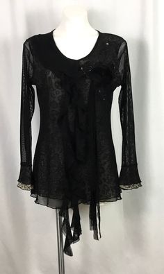 Pretty Angel -black blouse-semi Sheer-very fine soft netting over a sparkle animal print very fine net lining SIZE-L Scoop neckline-one side having a ruffle cascading down the front -the other side a flower appliqué -surrounded by black net and bugle beads-with four strands of fabric flowing from the flower down the front Ruffled sleeves 55% silk-35% rayon-10% spandex-good 4 way stretch Dry clean only  Like new condition Diane Freis, Syracuse Ny, Ruffled Blouse, Pretty Angel, Lace Chiffon, Chiffon Ruffle, Bugle Beads, Ruffled Sleeves, Chiffon Lace