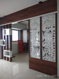 an empty room with decorative glass panels on the wall and wood trimming around it