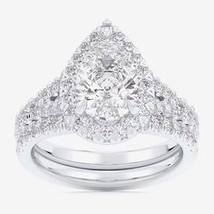 a white gold ring set with a pear shaped diamond