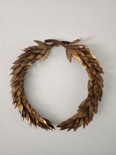 a wooden wreath made out of leaves on a wall