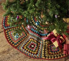 a christmas tree with presents under it on the floor