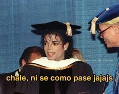 a man in a graduation cap and gown talking to a woman