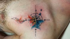 a man with a compass tattoo on his chest