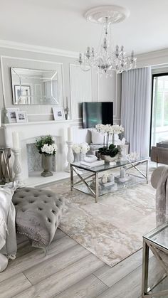 a living room filled with furniture and a flat screen tv on top of a fireplace