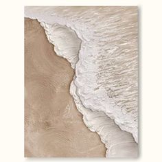 an aerial view of the ocean with waves crashing on it's shore and sand in the foreground