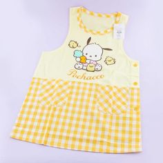 a yellow and white checkered dress with a hello kitty design on the chestline