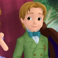 a boy in a green suit and bow tie standing next to a girl in a blue dress