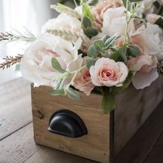 a wooden box with flowers in it and the words diy faux floral arrangement feminine rustic crate