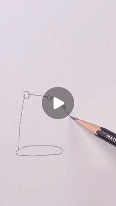 a pencil drawing an object on paper with the word math written in it and a video playing button