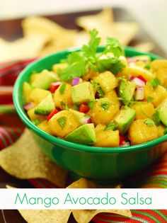 mango avocado salsa in a green bowl with tortilla chips on the side