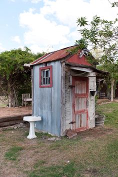 an outhouse with a toilet in the yard