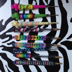 several different types of toothbrushes lined up on a zebra print wall