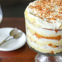 a cake with white frosting and sprinkles sitting on top of a table