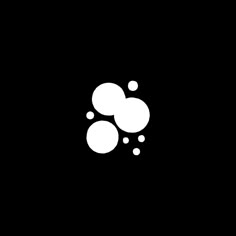 two bubbles floating in the air on a black background