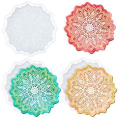 four different colored paper dois with intricate designs on the edges and sides, all in various colors